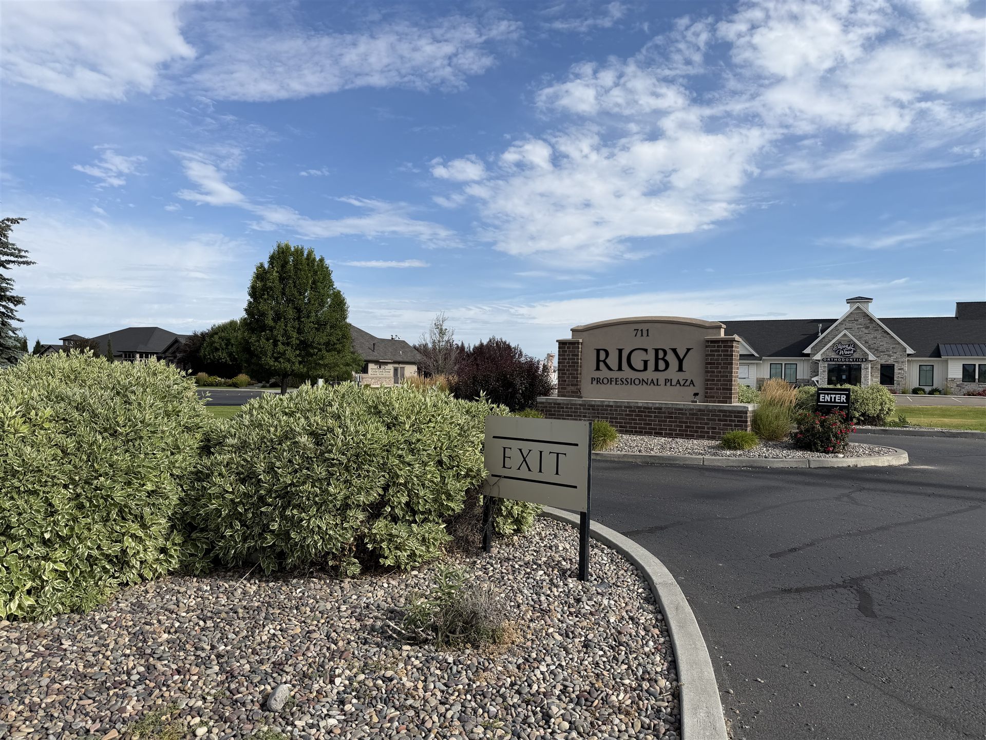 Rigby Professional Plaza — the entrance drive with the ENTER and EXIT signs
